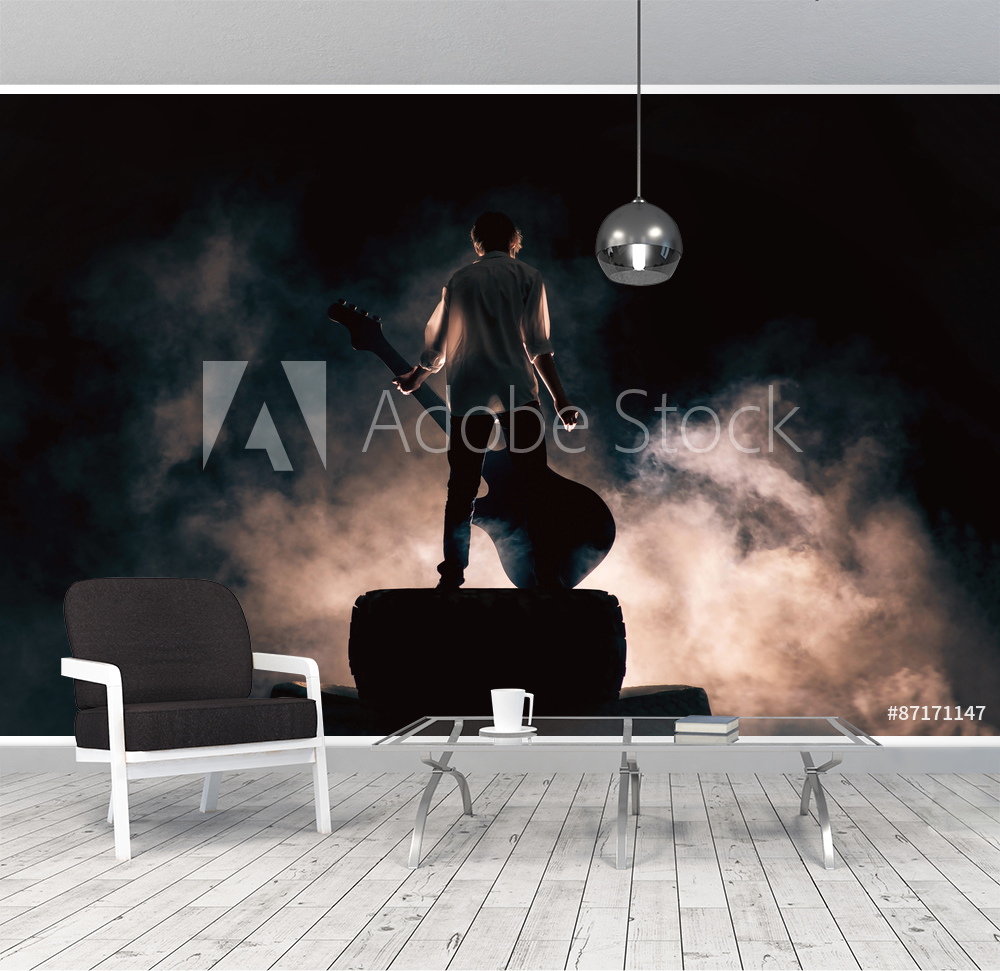 Picture of Rock musician and large guitar a lot of smoke